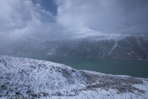 Lake in Sikkim surrounded by snow-capped mountains