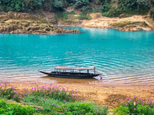 Boat floating on crystal clear Umngot river in Dawki Meghalaya